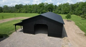 Aerial view of a 40x60 matte black pole barn in Clarence, NY, showcasing Stately Pole Barns' durable construction with Perma-Column Sturdi-Wall Brackets and Everlast II Steel Panels.